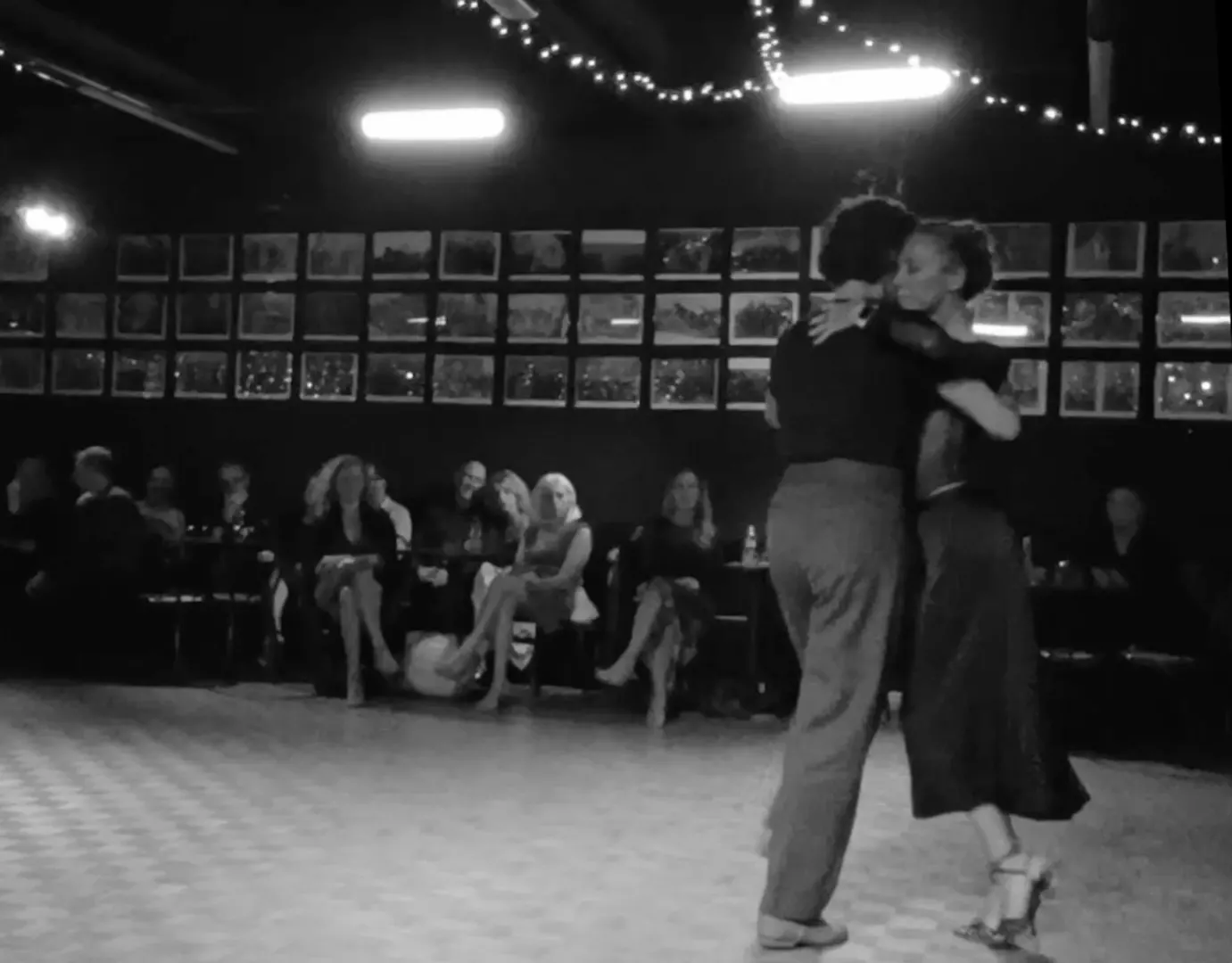 Axis & Alchemy Couple dancing Argentine tango at a milonga